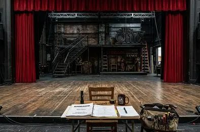 Performers rehearse under warm stage lights