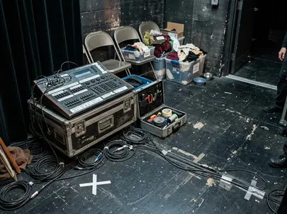 Production equipment, backstage technical area in a working local theatre: coiled cables on the floor